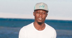 Abu Azeez turns model, models beach soccer shirt