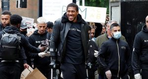 Anthony Joshua hobbles on crutches as he joins Black Lives Matter protest in Watford