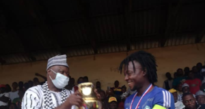 REVEREND FATHER WINS RAFFLE DRAW STAR PRIZE. …. wears shirt with inscription ” It’s been God All the Way”..